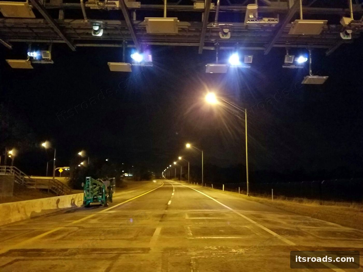 Open road tolling gantry at night with readers and cameras